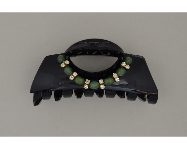 Glossy black clamp with green beads and diamante decoration. Approx 8.5cm
