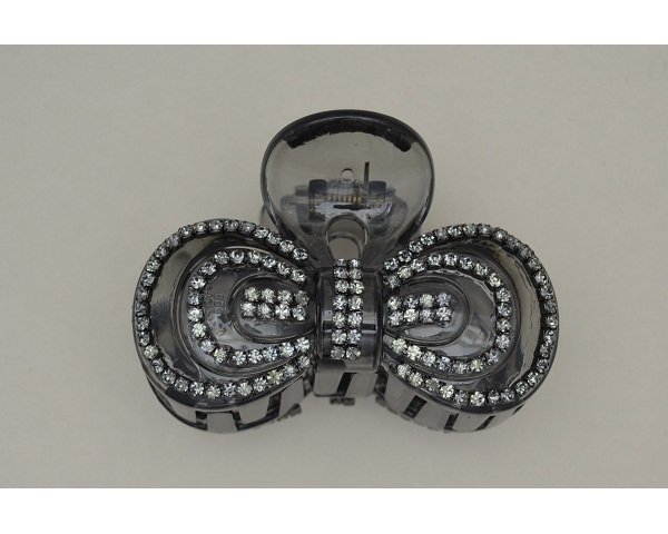 Bow shaped translucent black clamp decorated with silver beads. Approx 8cm