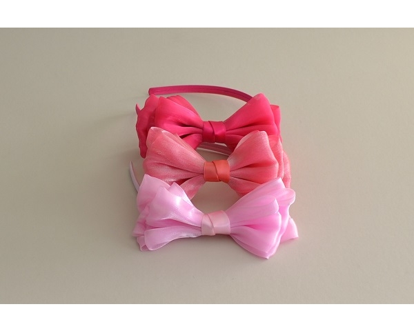 Shimmery side mounted bow on sateen covered alice band. Packed assorted colours as per images