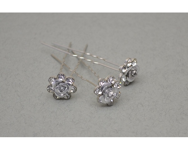 Silver hair pin with centre rose outlined with crystals. Packed 12 pins per container