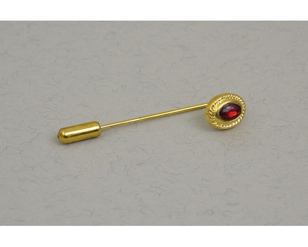 Gold cravat pin with red gemstone