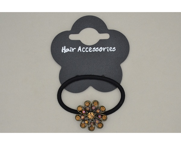 Metal flower on black elastic with coloured diamantes. Packed assorted green & amber brown