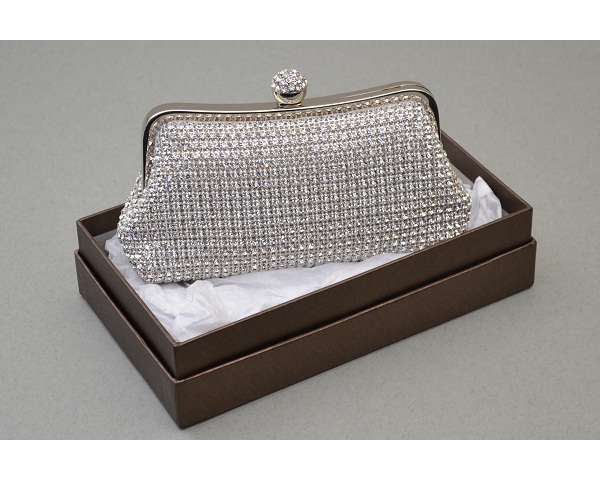 Silver clutch bag covered in crystal stones with a round clasp encrusted with crystals. Long chain included.