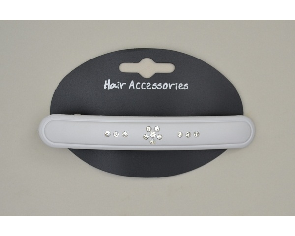 Slim oblong acrylic barrette with rubberised finish and diamante design. In brown & white